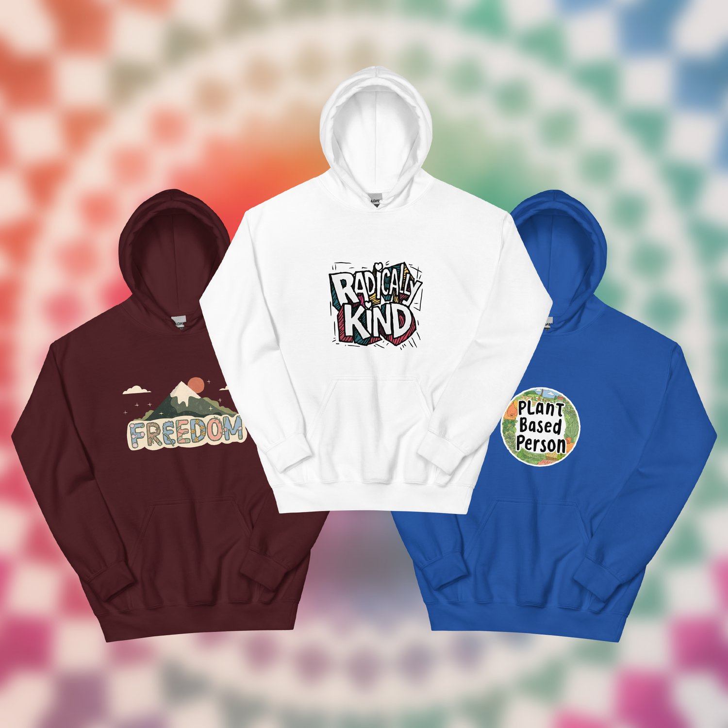 Three unisex hoodies in red, white, and blue colours displayed against a rainbow background