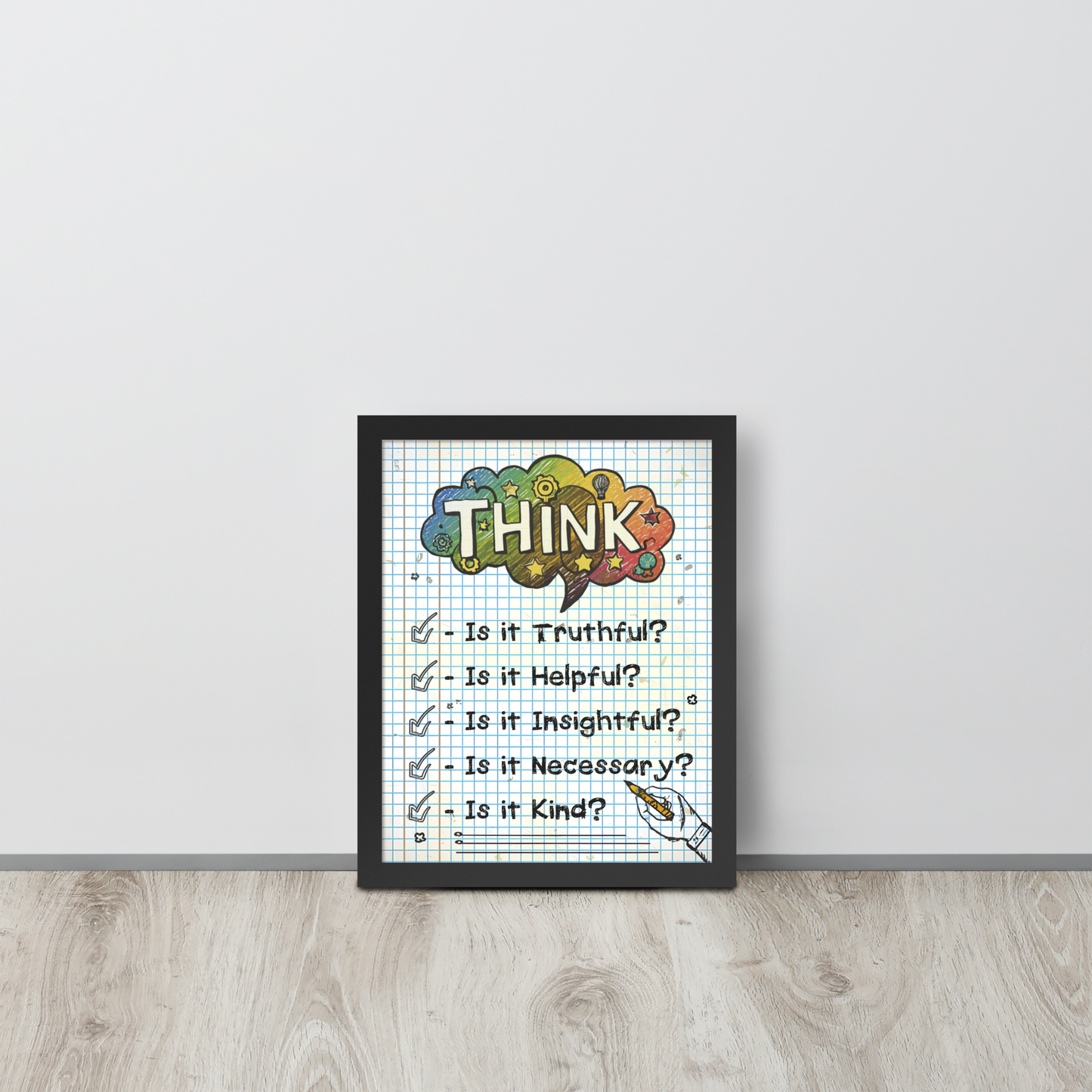 Framed illustrated poster with a white frame titled 'THINK' featuring a checklist with items: Is it Truthful?, Is it Helpful?, Is it Insightful?, Is it Necessary?, Is it Kind?. The poster is leaning against a white wall on a wooden floor.